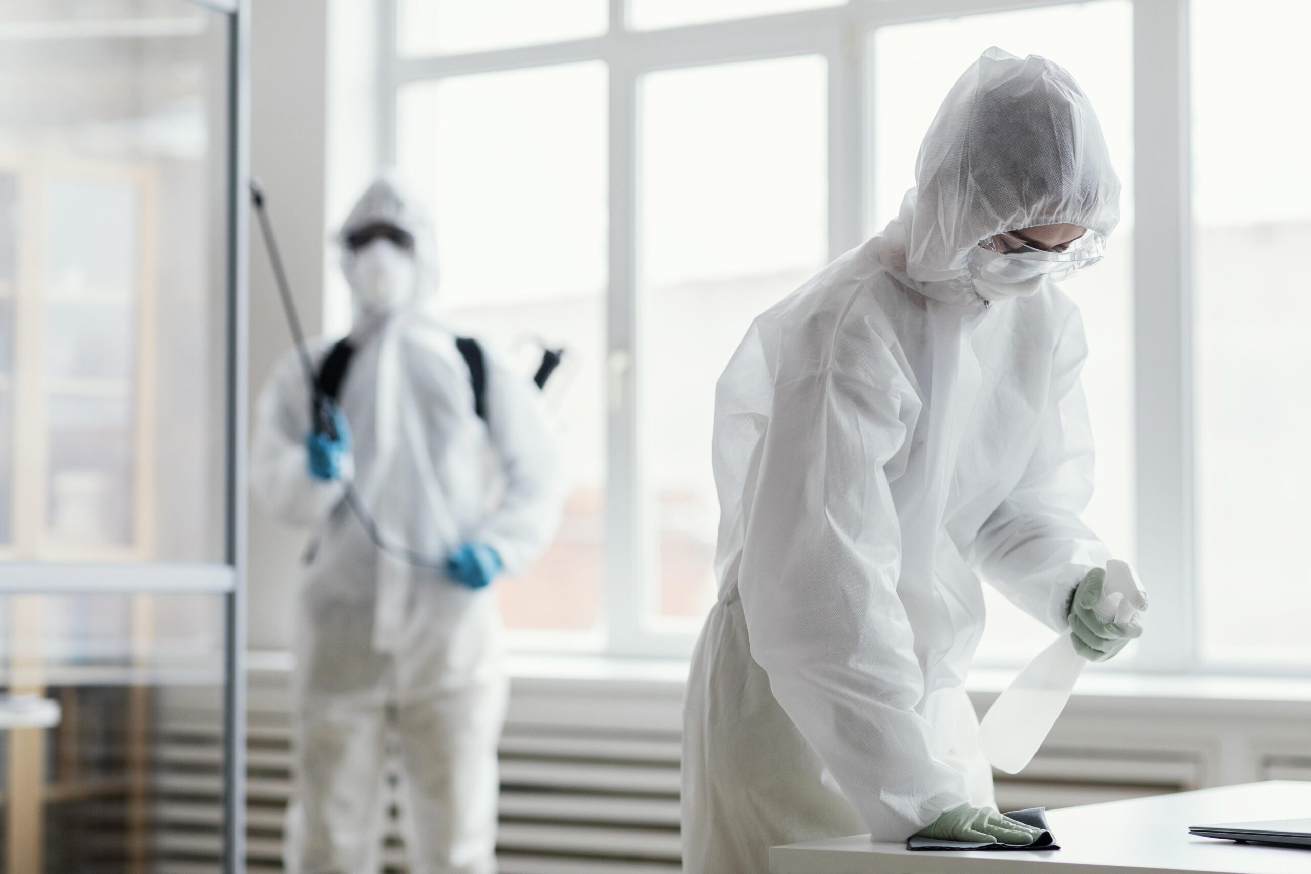 Professional PPE-equipped technician inspecting property